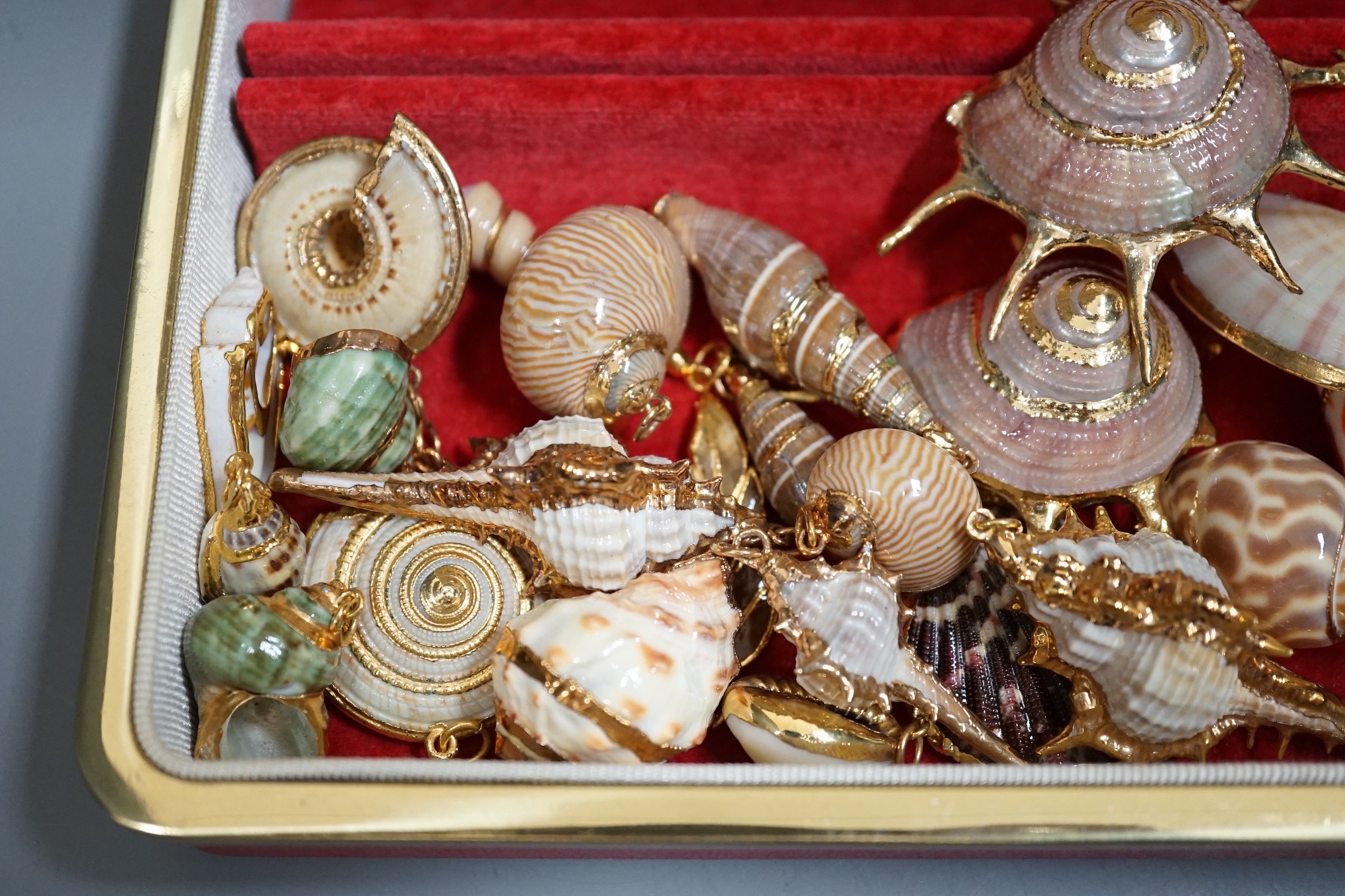 A small group of assorted gilt mounted sea shell pendants. largest 69mm.